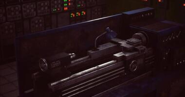 CGI Lathe machinery in a dimly lit workshop at night with control panels video
