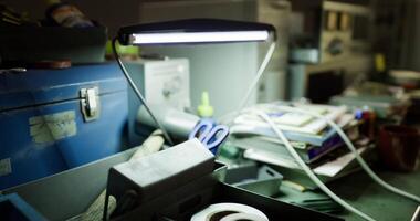 CGI Desk workspace with tools and a lamp illuminating various items video