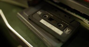 CGI Retro cassette tape resting on a shelf in a cozy music collection space video