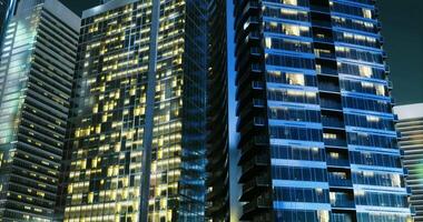 CGI Urban skyline illuminated at night showcasing modern architecture video