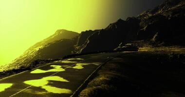 CGI Winding road through dramatic landscape illuminated by yellow light video