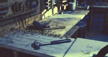 CGI Crafting tools and wood shavings in a dimly lit workshop space video