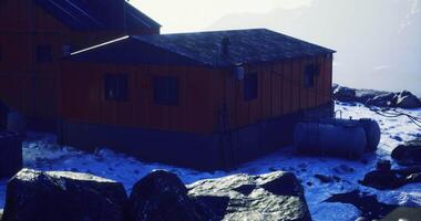 CGI Winter cabins nestled in a snowy mountain landscape at dawn video