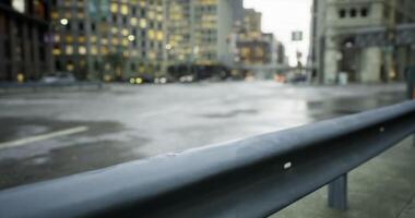 CGI Evening rain creates reflections on city streets near tall buildings video
