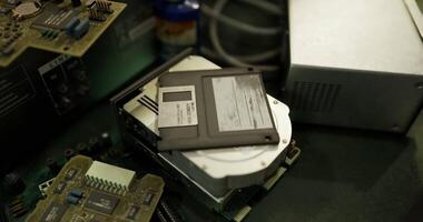 CGI Old computer hardware and floppy disk on a workbench in a workshop video