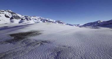 CGI A breathtaking view of a snow covered mountain range under a vibrant blue sky video