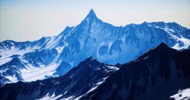 CGI Snow capped mountain peak towering over rugged landscape in daylight video