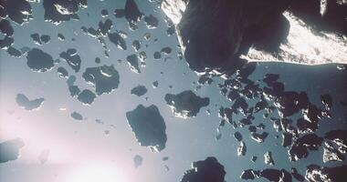 CGI Exploring a dense field of asteroids in deep space with bright light video