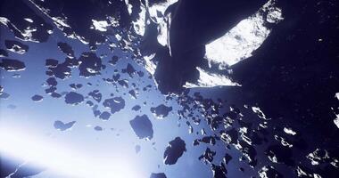CGI Exploring a vast asteroid field illuminated by distant stars in deep space video