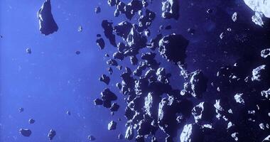 CGI Asteroids drift through the vast emptiness of space in a cosmic show video