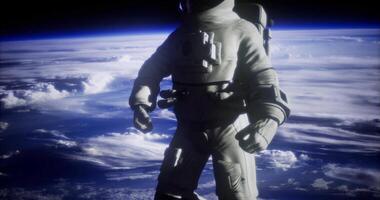 CGI Astronaut floating in space above Earth with clouds visible video