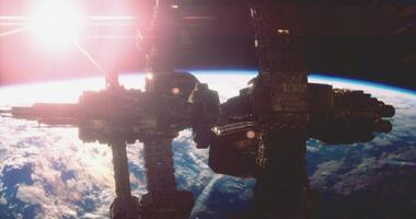 CGI Space station orbiting Earth during sunrise with vivid light reflection video