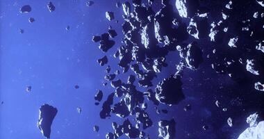 CGI Asteroids floating in the vastness of space under distant stars video