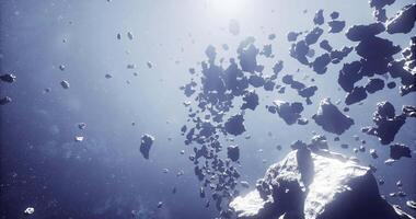 CGI Asteroid belt floating in space with sunlight illuminating fragments video