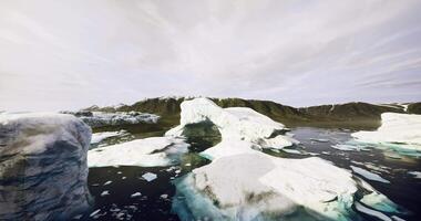 CGI Wide view of icebergs floating in a tranquil Arctic landscape under soft clouds video