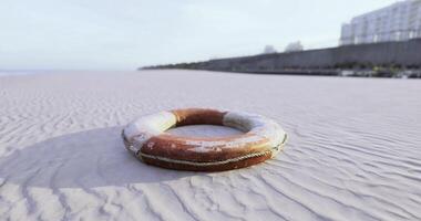 CGI Lifebuoy resting on sandy beach with calm ocean in the background video