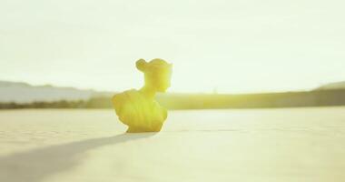 CGI Bright yellow sculpture stands against a sunlit background at dawn video