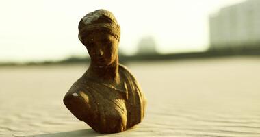 CGI Statue of a woman emerges from shifting sands during sunset on a beach video