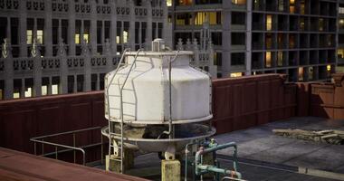 CGI Water tower on a rooftop with city skyline backdrop during twilight video
