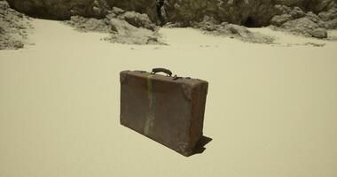 CGI Old suitcase resting on sandy beach with rocky backdrop during daytime video