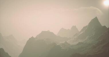 CGI Majestic mountain range under a soft hazy sky at sunset video