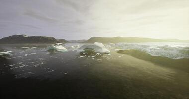 CGI Icebergs float serenely in the calm waters during golden hour near the coast video