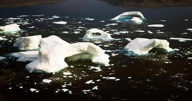 CGI Large, white icebergs are scattered across dark water in an Arctic region video