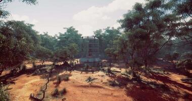 CGI Abandoned tower surrounded by trees in a remote landscape during daylight video