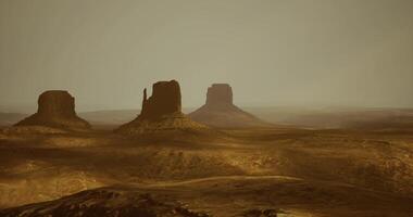 CGI Majestic sandstone buttes under a hazy sky at dusk in a desert landscape video