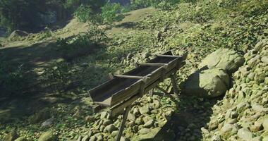 CGI Wooden trough in a natural setting surrounded by greenery and stones video