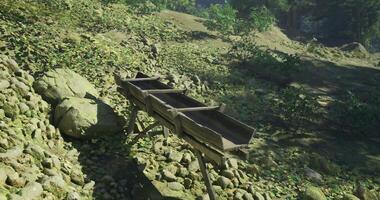 CGI Wooden structure for water collection in a forested area during daytime video