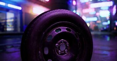 CGI Urban tire rests on wet pavement amidst neon signs at night video