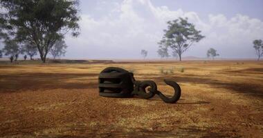 CGI Ancient iron hook resting on arid ground under a clear sky video