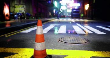 CGI Traffic cone positioned on wet street in neon lit urban environment at night video
