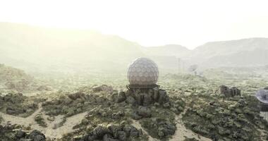 CGI Structure in desolate terrain with mountains and a hazy sky at dawn video
