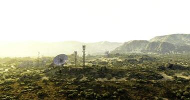CGI Communication towers stand tall against a vast mountainous landscape at dawn video