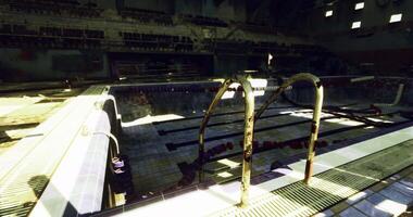 CGI Old indoor pool with rusty ladder and worn tiles in abandoned facility video
