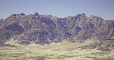 CGI Rocky mountain landscape with clear sky during daytime in serene setting video