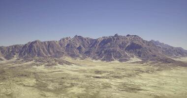 CGI Mountain range with vast desert landscape under clear blue sky video