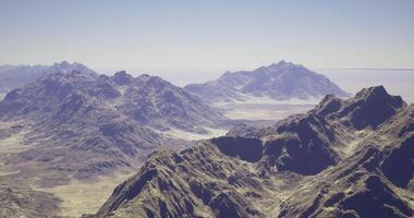 CGI Mountain range with rugged terrain under a clear sky during daytime video