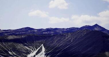 CGI Mountains with unique lines and textures under a clear blue sky video