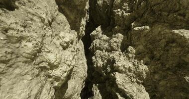 CGI Detailed view of rocky terrain in a narrow canyon during daylight hours video