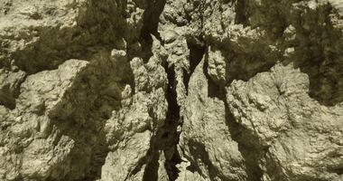 CGI Rock formation with deep fissure under sunlight in a natural landscape video
