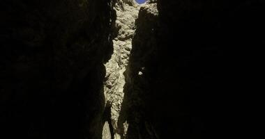 CGI Light streaming through a narrow canyon crack in a rugged landscape video