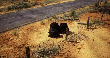 CGI Trash bags left on roadside in arid environment highlight littering issue video