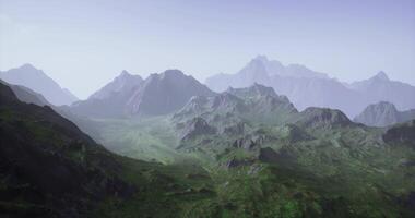 CGI Vast mountain range under clear sky with green valleys in daylight video
