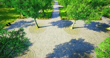 CGI Park pathway with lush trees and circular walkways in daylight video