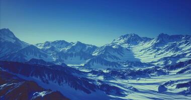 CGI Snow capped mountain range under clear blue sky during daytime video