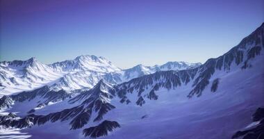 CGI Snow covered mountains under clear sky during early morning light video