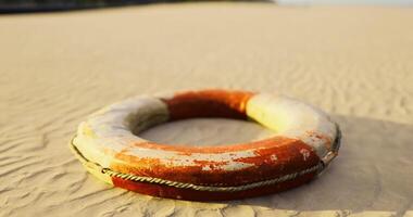 CGI Lifebuoy resting on sandy beach during sunset near ocean waves video